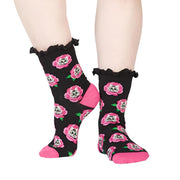 PERSON WEARING BLACK FRILLED CREW SOCKS WITH PINK ROSES AND KITTENS