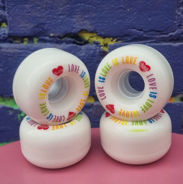 white outdoor roller skate wheels with 'love is love' rainbow colours on print 