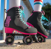 person wearing black high top retro rollerskates, blue laces, black 78a outdoor wheels, pink sole heel 'Chaya' 