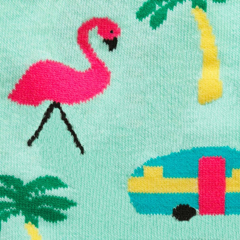 CLOSE UP OF MINT GREEN CREW SOCKS WITH PATTERN OF RETRO CARAVANS FLAMINGOS AND PALM TREES