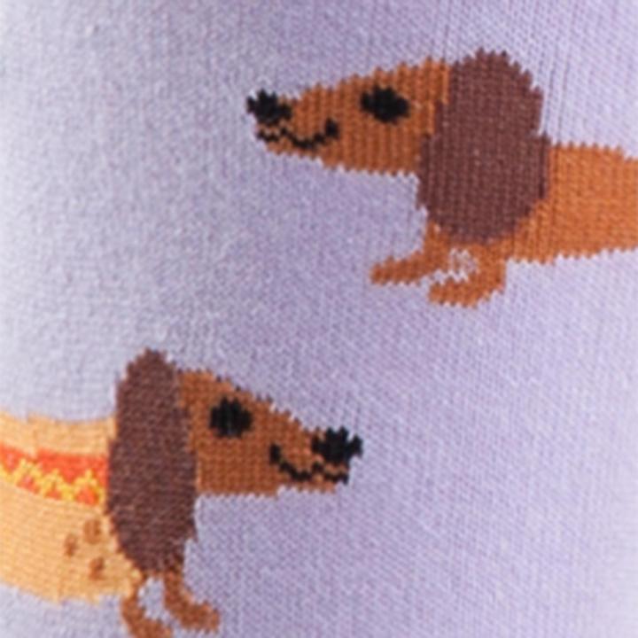 CLOSE UP OF LILAC CREW SOCKS WITH YELLOW HEEL AND TOE WITH PATTERN OF SAUSAGE DOGS