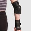 person wearing black impala protective set, wrist guards, elbow pads