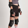 person wearing black impala protective set, wrist guards, elbow pads, knee pads 
