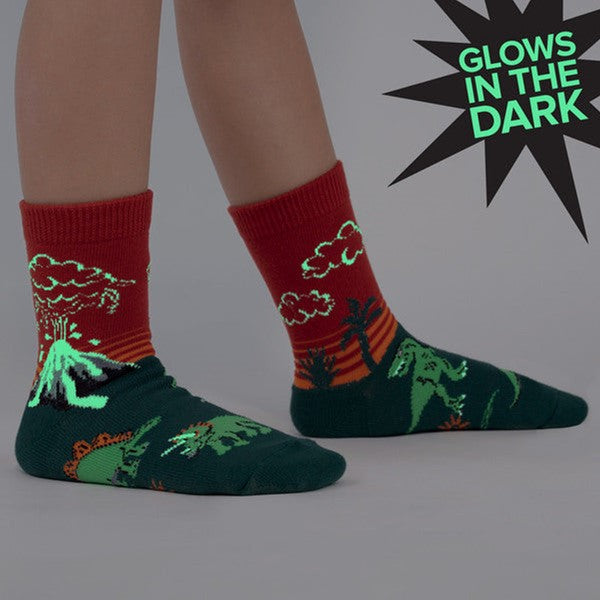 KID WEARING CREW SOCK WITH GLOW IN THE DARK VOLCANO AND DINOSAURS