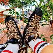 black suede high top roller skates with leopard laces and clear moxi outdoor wheels