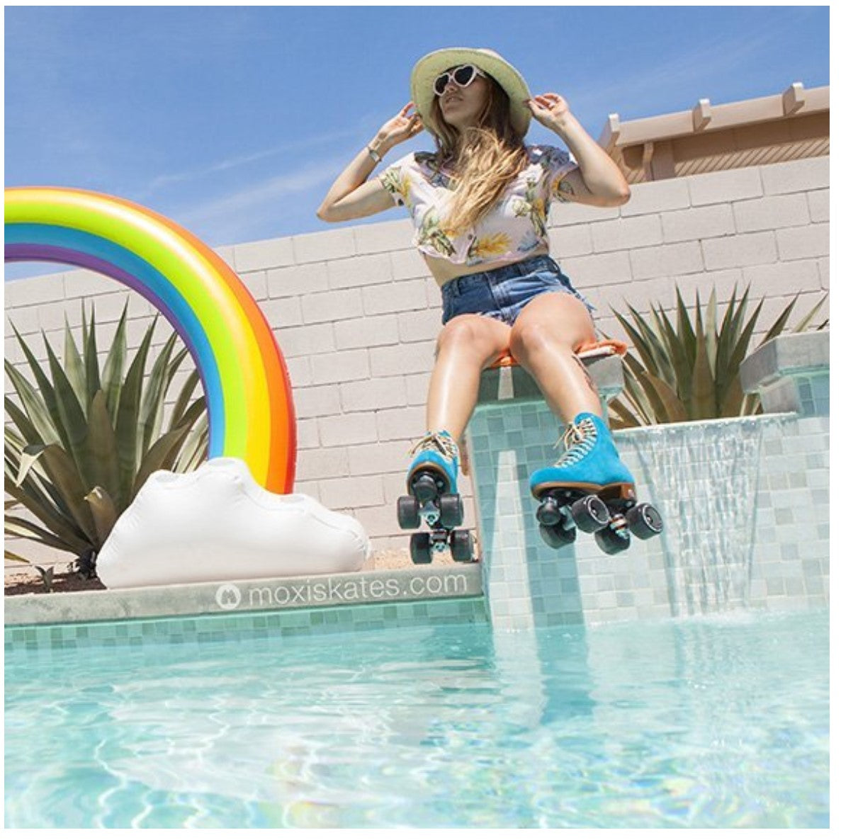 girl wearing blue moxi rollerskates by pool 