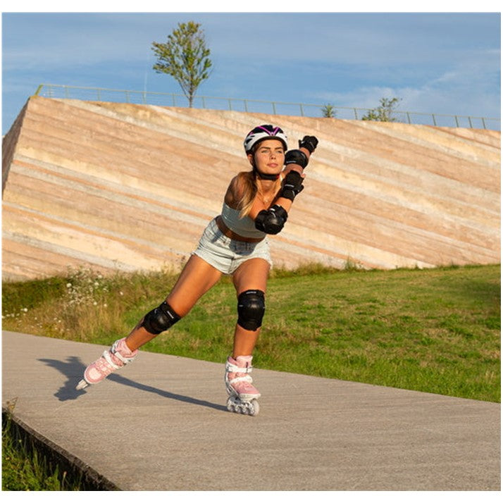 women skateing in pink and white inline skates 