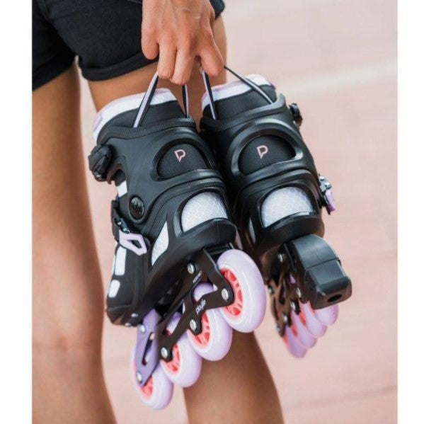 PERSON HOLDING PURPLE WHITE INLINE SKATES