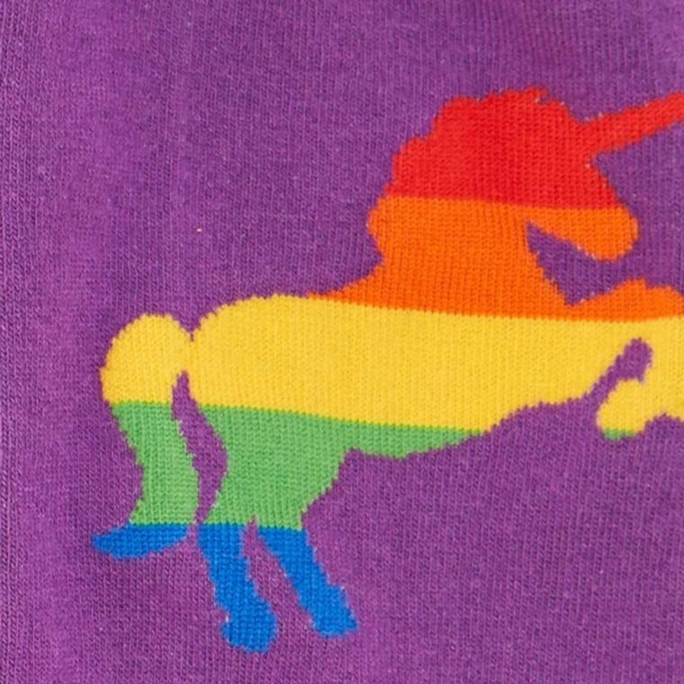 CLOSE UP OF PURPLE KNEE HIGH SOCKS WITH PAINBOW STRIPED UNICORNS PATTERN