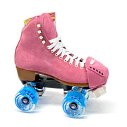 pink roller skate with blue moxi wheels and light pink suede toe guard protectors with silver studs