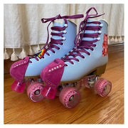 blue roller skates with pink moxi wheels and pink fuschia suede toe guard protectors with silver studs