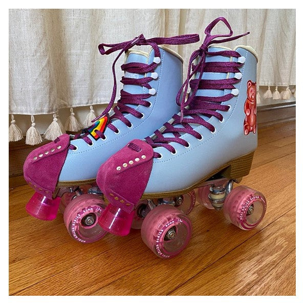 blue roller skates with pink moxi wheels and pink fuschia suede toe guard protectors with silver studs