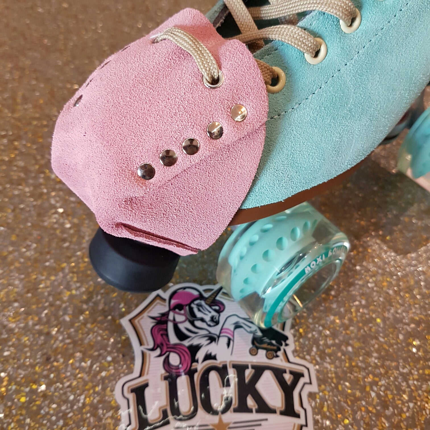 blue moxi lolly roller skate with pink strawberry suede toe guard protectors with silver studs