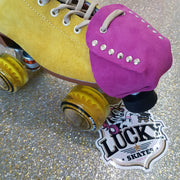 yellow moxi lolly roller skate with pink fuschia suede toe guard protectors with silver studs