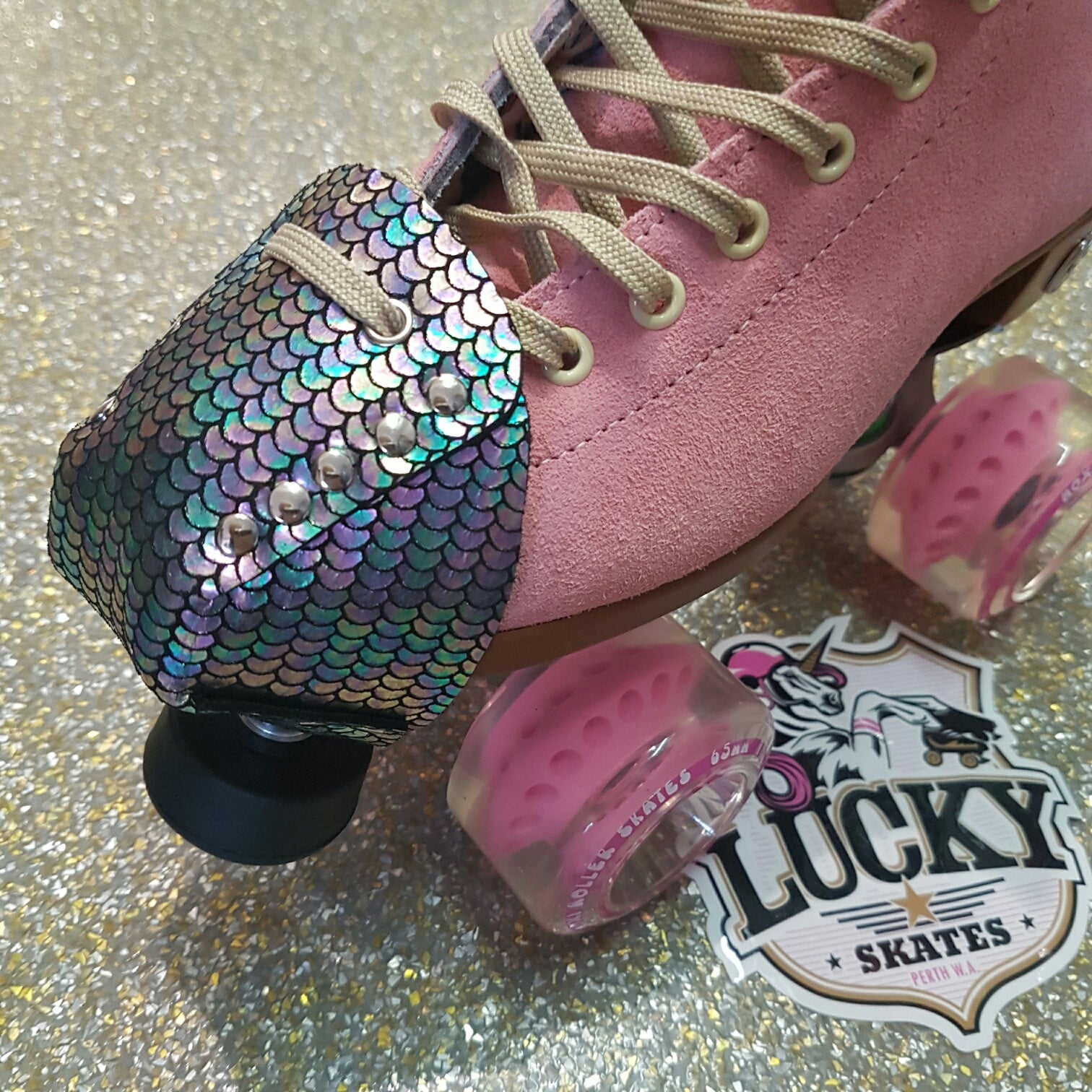 pink moxi lolly roller skate with metallic multi-coloured meramid toe guard protectors with silver studs