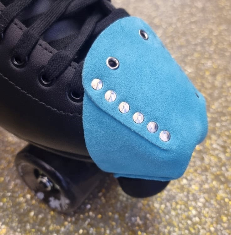 black roller skate with light bright blue leather suede toe guard protectors with silver studs