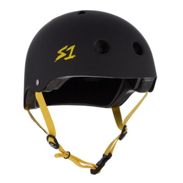 matt black skate helmet with yellow straps and text on the side