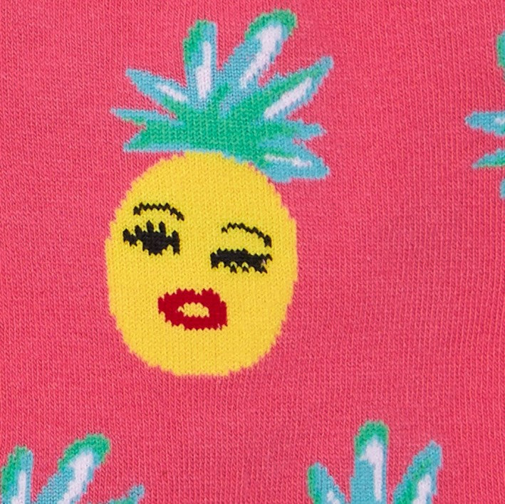 CLOSE UP OF PINEAPPLE WINKING FACE ON PINK CREW SOCKS