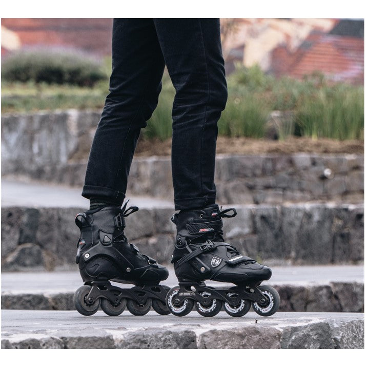 PERSON OUTSIDE SKATING IN BLACK SEBA INLINE ROCKERED SKATES