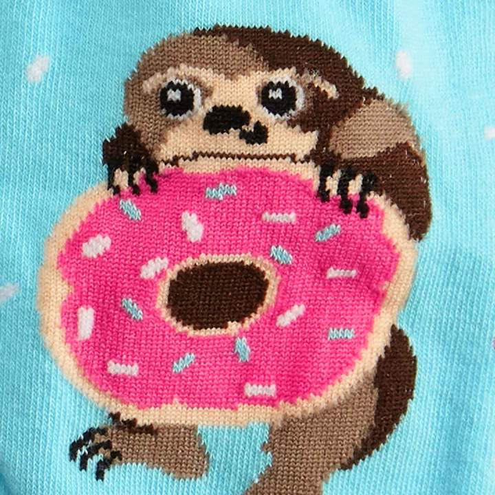 CLOSE UP OF SLOTH HOLDING PINK DONUT PATTERN ON BLUE SOCK