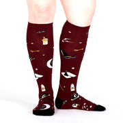 PERSON WEARING MAROON KNEE HIGH SOCKS WITH PATTERN OF MAGIC POTIONS