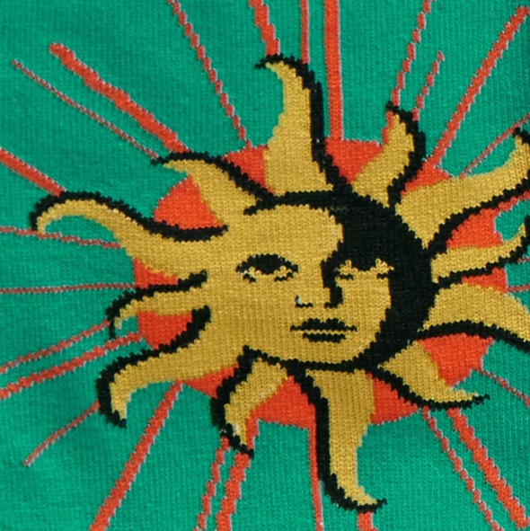 CLOSE UP OF SUN WITH FACE ON GREEN SOCK