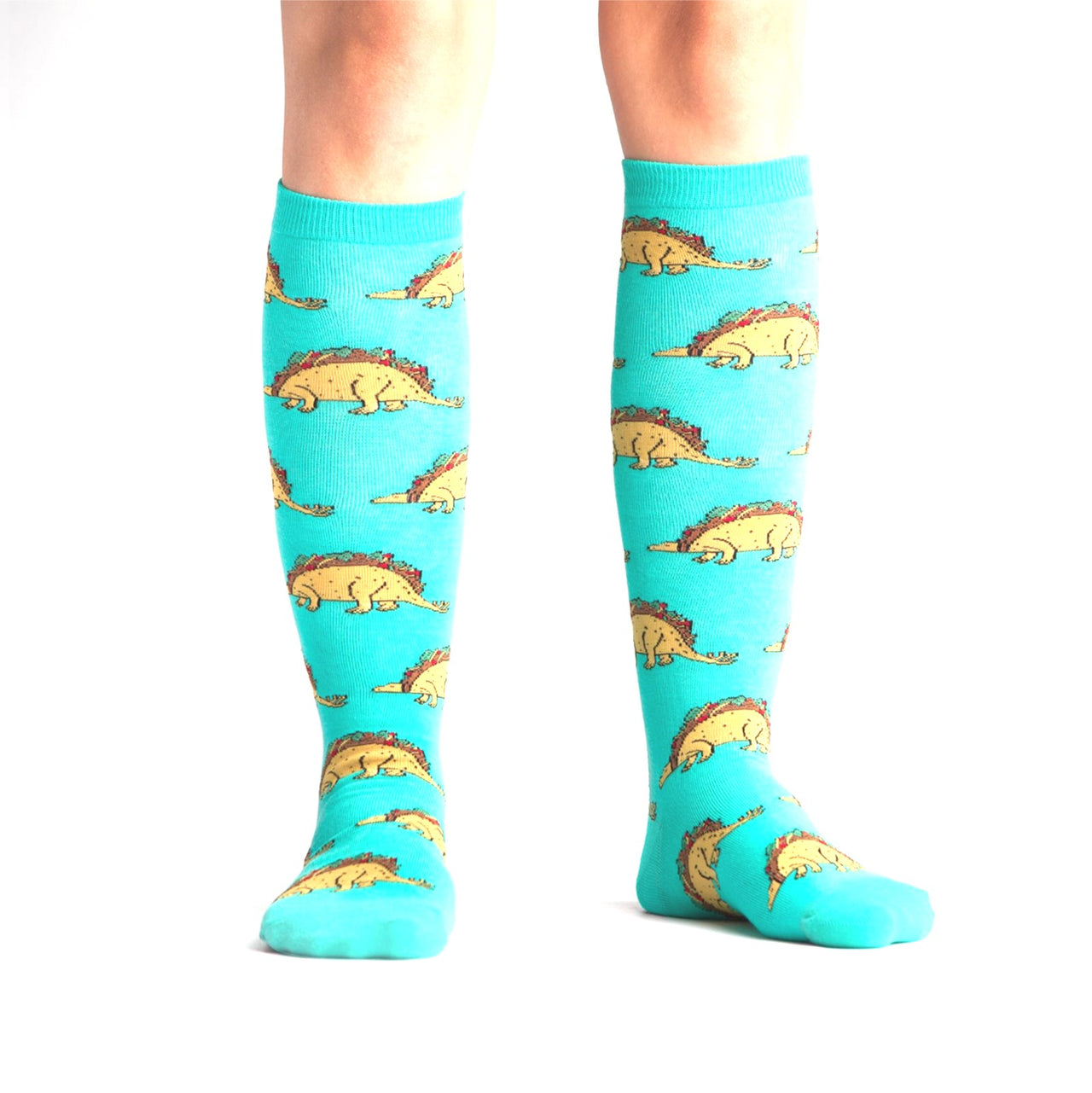 PERSON WEARING TEAL KNEE HIGH SOCKS WITH TACO DINOSAURS