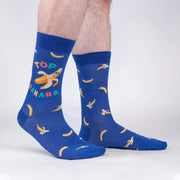 PERSON WEARING BLUE CREW SOCK WITH BANANA PATTERN