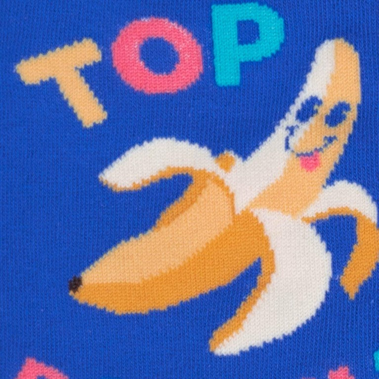 CLOSE UP OF BANANA WITH SMILEY FACE ON BLUE CREW SOCK