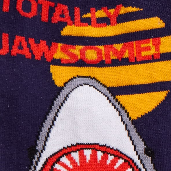 CLOSE UP OF SHARKS HEAD AND TEXT "TOTALLY JAWSOME!" ON NAVY BLUE SOCK